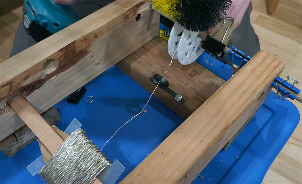 A spool loaded with lights and set up for the drill-brush winding jig